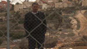Palestinian Mayor stands behind fence